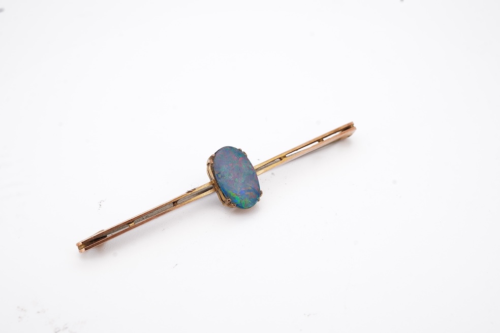 An early 20th century 9ct and single stone oval black opal doublet set bar brooch, 57mm, gross weight 2.3 grams, in an Asprey box. Condition - fair